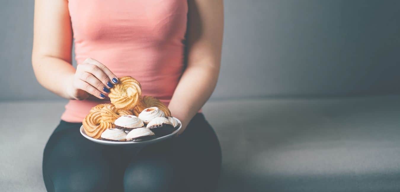 woman snacking on couch at night