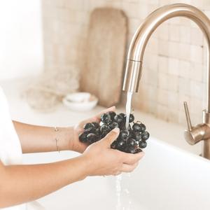 woman washing grapes