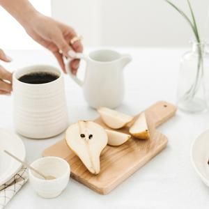 sliced pears and mug of coffee